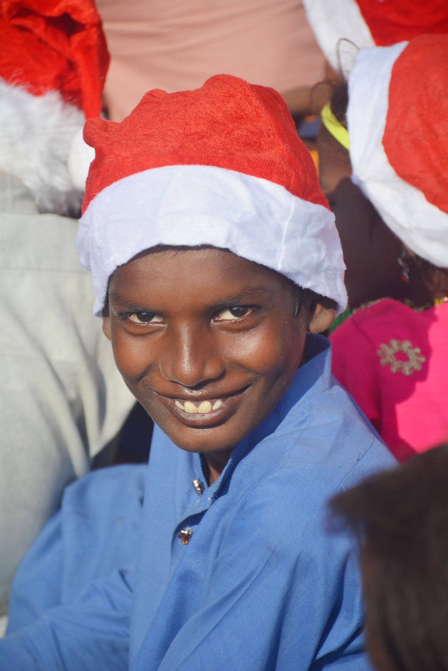 A child receiving a gift during a charity visit