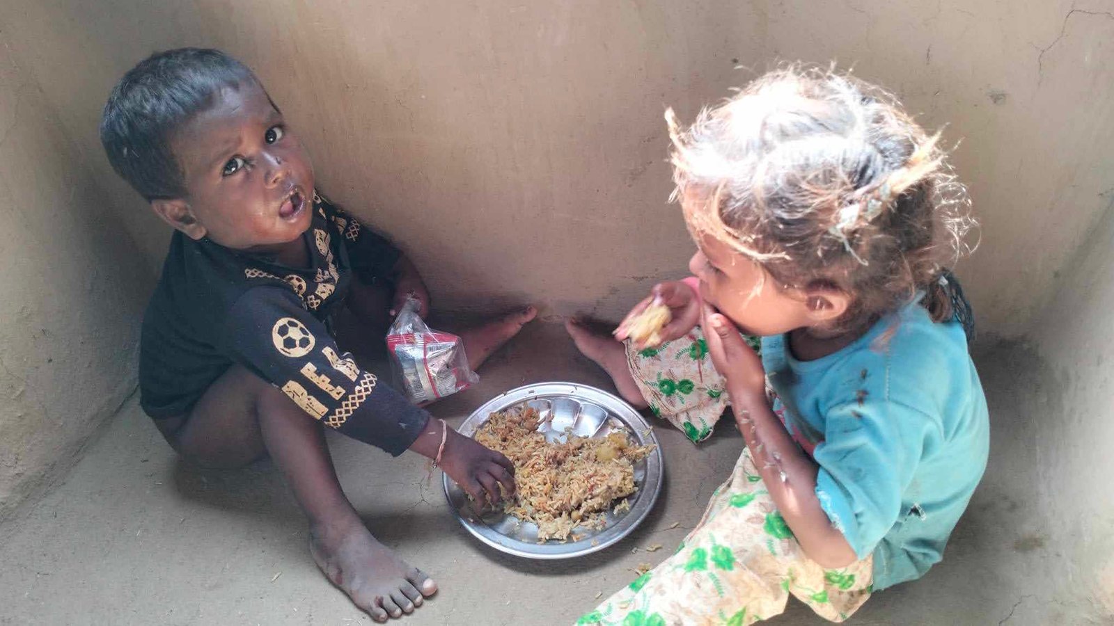 Children sharing a meal provided through charity